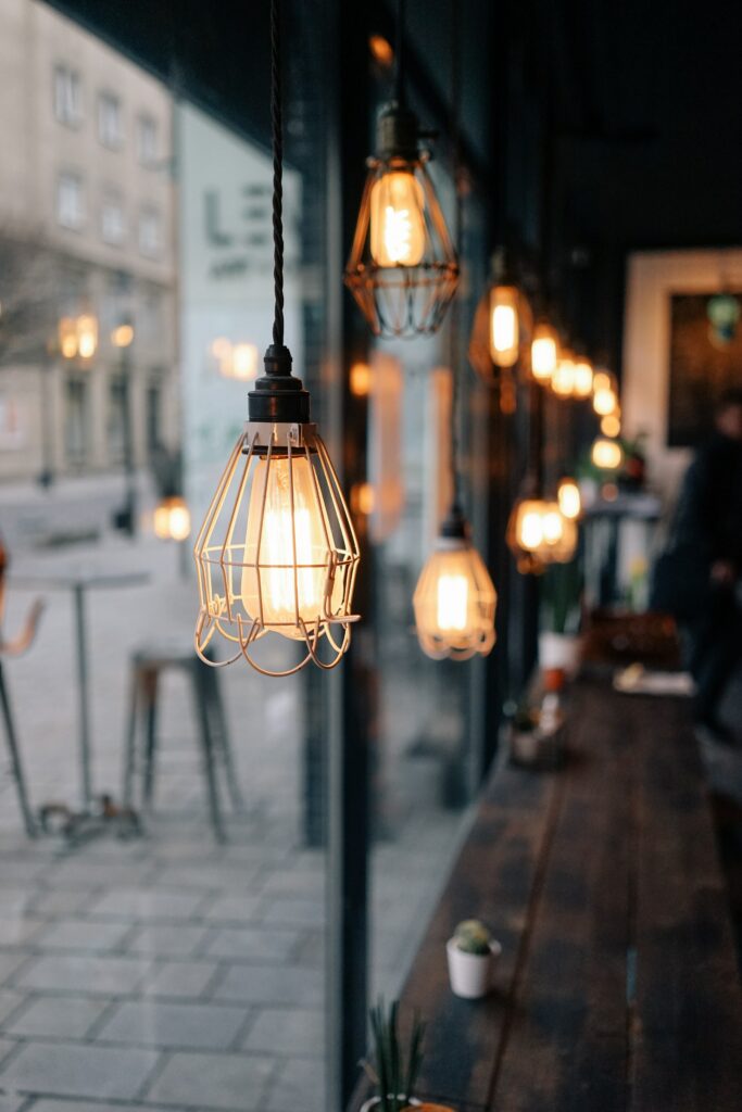 An industrial type of lighting by the window of a cafe. Placed on the inside gives a nice glow and makes the cafe more inviting from the outside. 