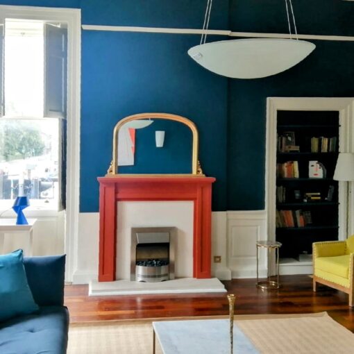 Living room with blue walls and red fireplace