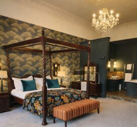 Boutique hotel bedroom in Edinburgh, designed with luxury fabrics, wallpaper and furniture.